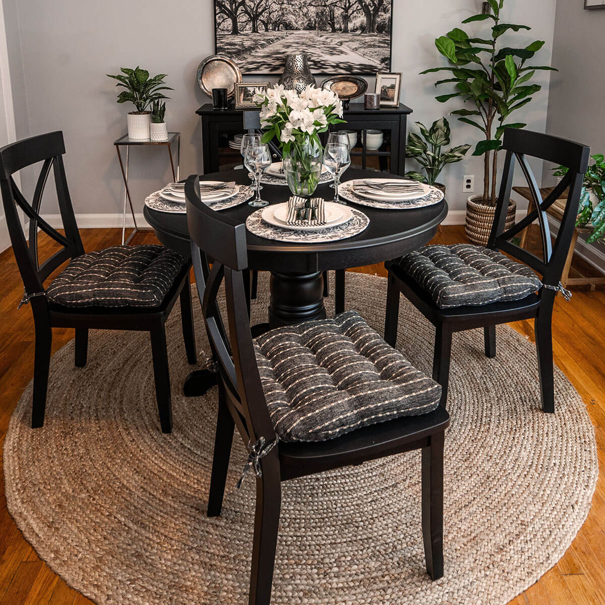 natural and black striped dining room chair cushions on black crossback dining chairs in formal dining room