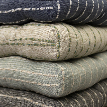 stack of dining room chair pads with box corners in navy blue natural aqua and dark grey