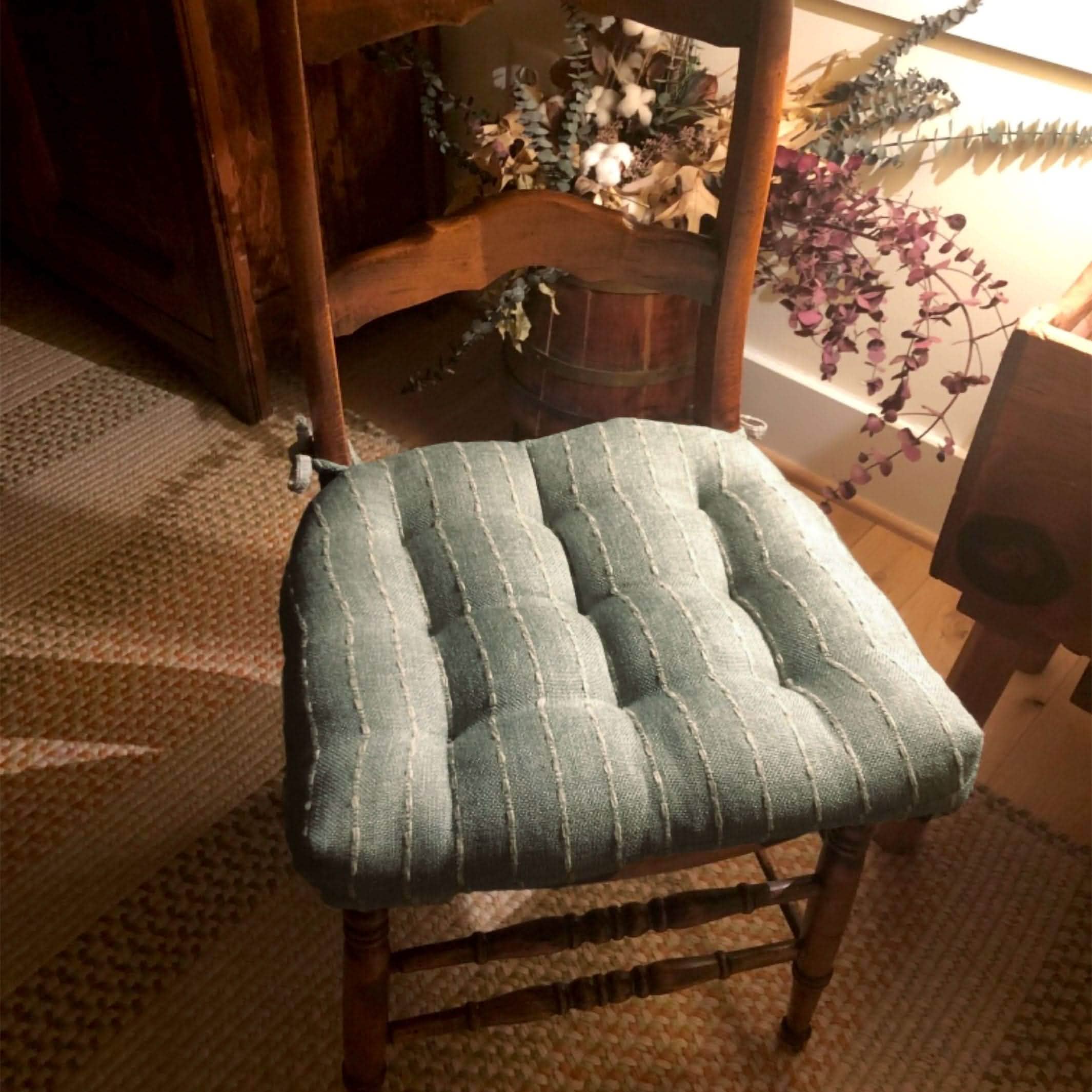 spa colored dining chair pad on ladderback chair in country dining room