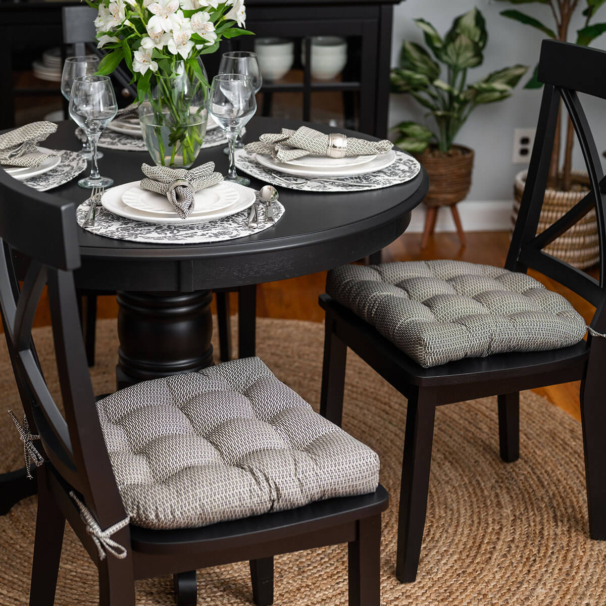 black basketweave dining chair cushions on black dining chairs in formal dining room