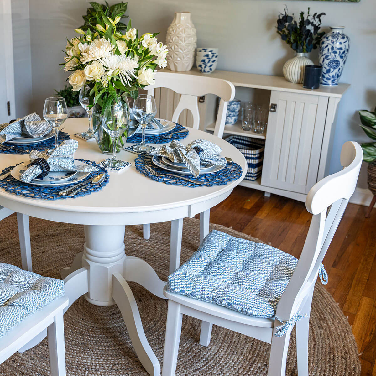 navy blue basket weave dining chair cushions on white dining chairs in transitional dining room