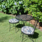 blue floral round chair pads on outdoor bistro chairs and table set in the garden with hydrangeas