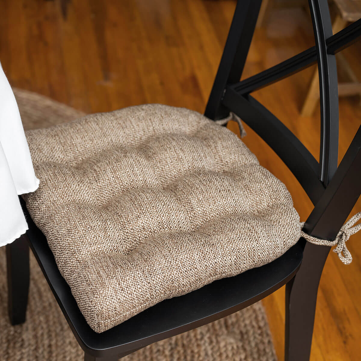 neutral colored tweed dining chair pads on formal dining chair