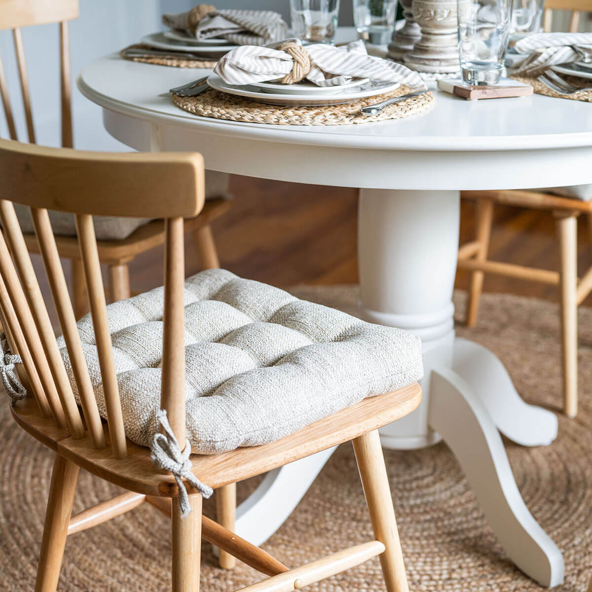 natural dining chair cushions in neutral colored dining room design with sisal rug and woven placemats