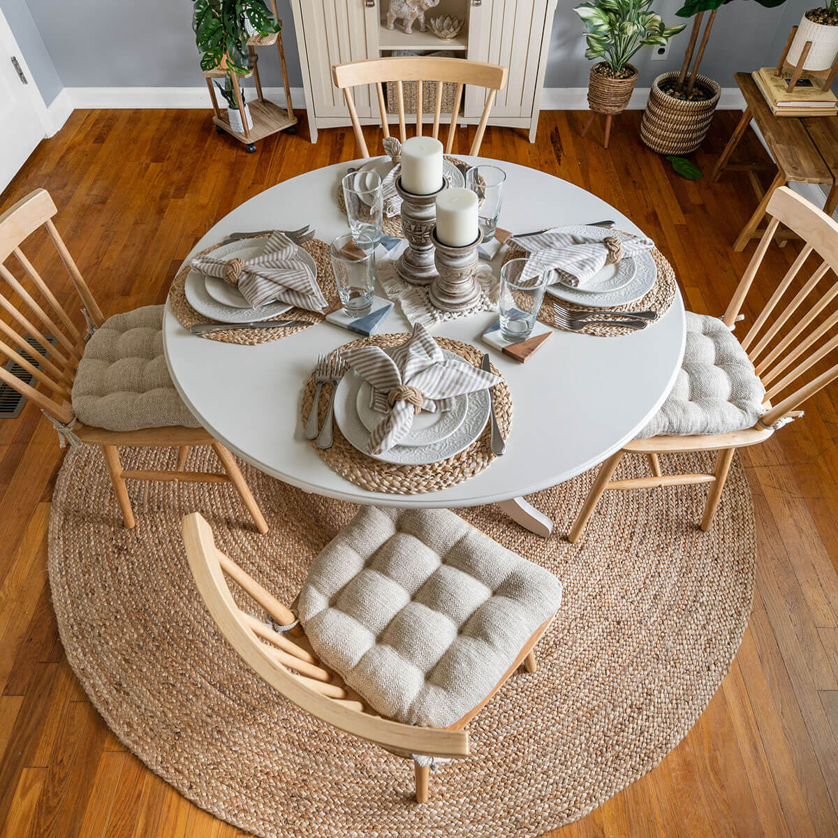 neutral colored dining room design with natural and white dining chair pads