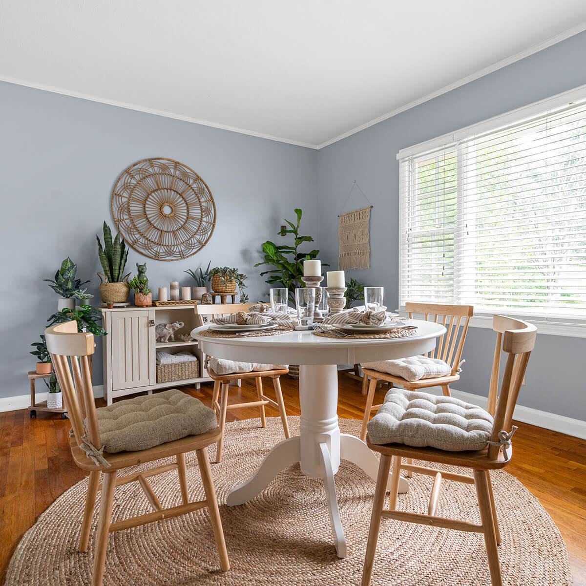 boho dining room with small table and natural dining chair pads on wood dining chairs