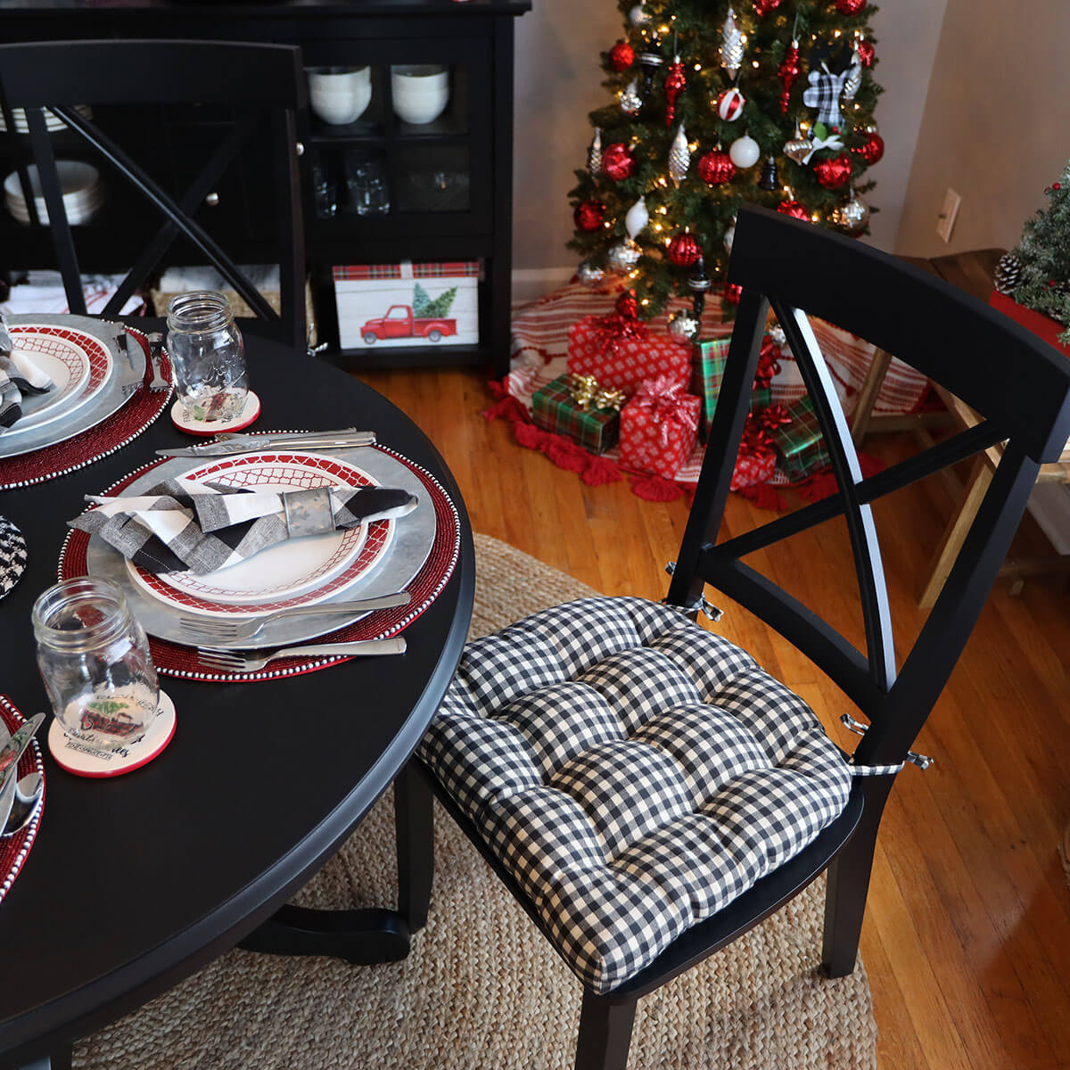 checkered chair pads in farmhouse dining room decorated for christmas with buffalo check theme