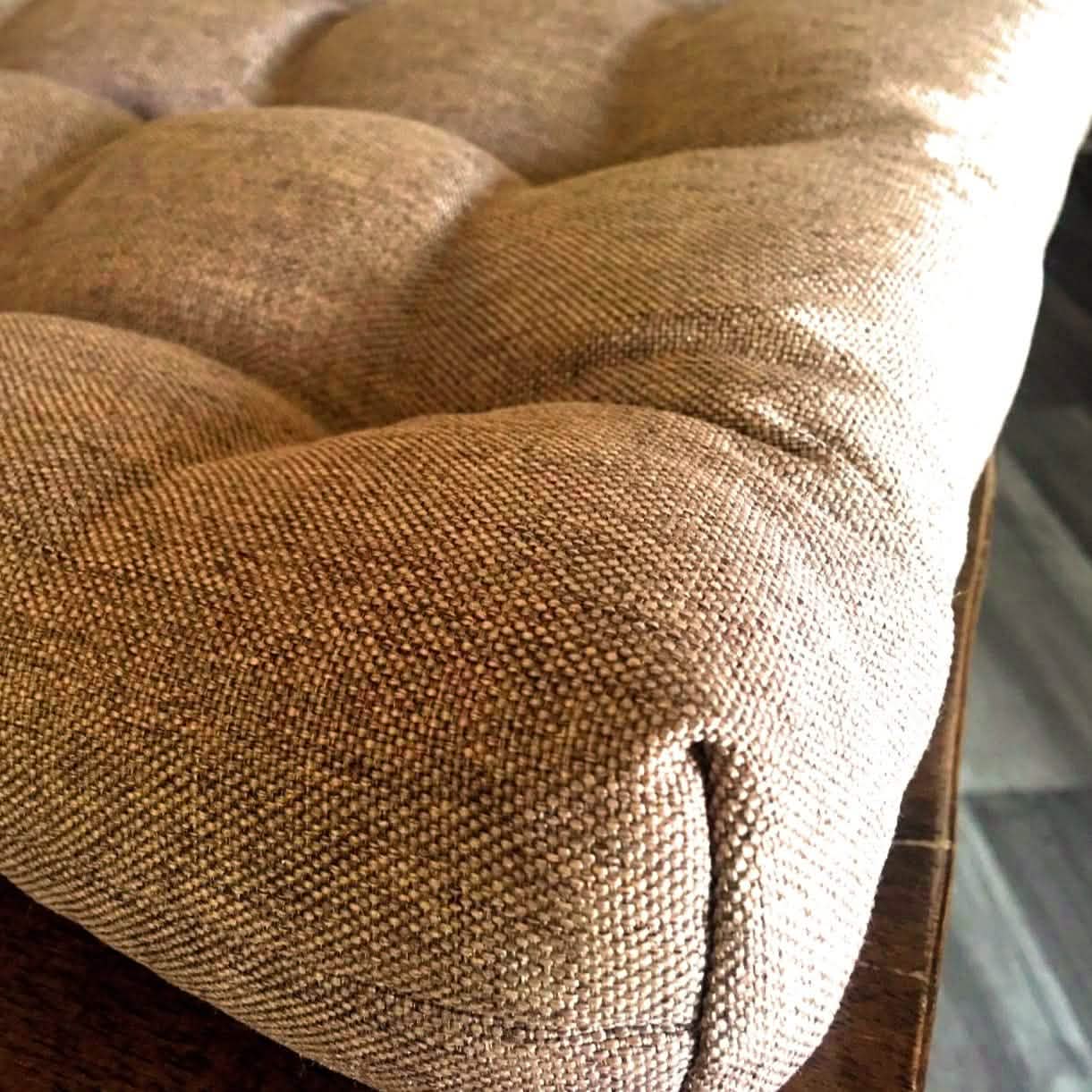 close up of box corner cushion detail in copper color fabric on wood dining chair
