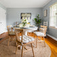 gingham plaid chair pads on spindle back chairs in farmhouse kitchen decorated in natural colors