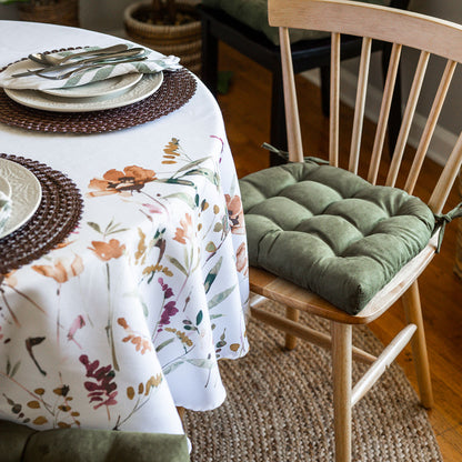 microsuede laurel green dining chair cushion on wooden dining room chair at table set for fall