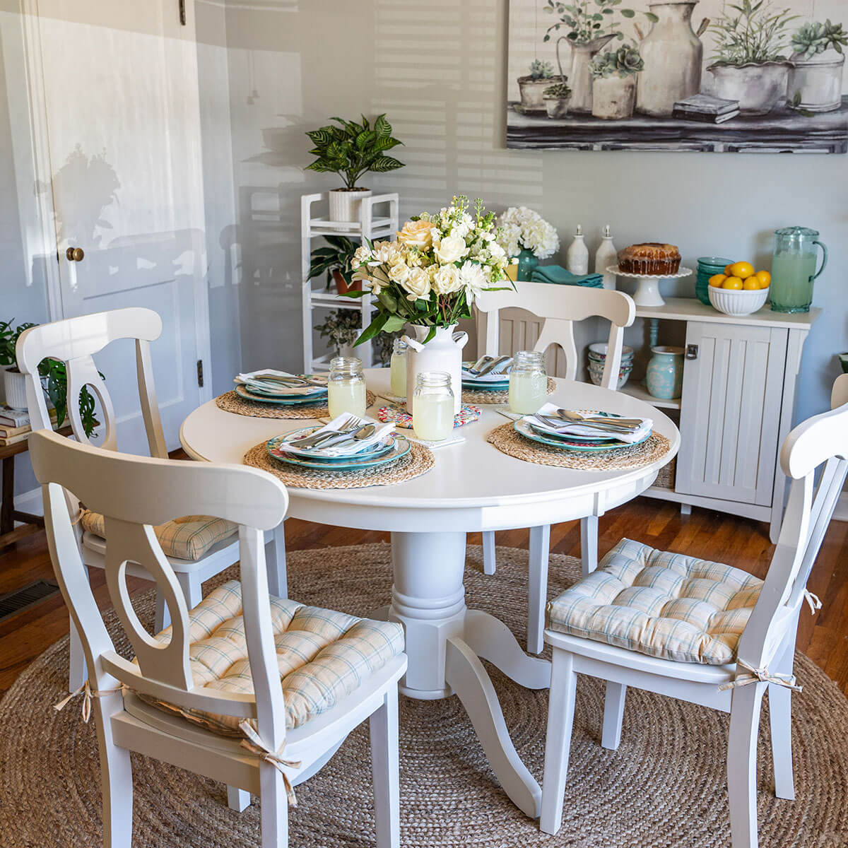 yellow plaid dining chair cushions on white dining chairs in farmhouse kitchen with lemons and aqua