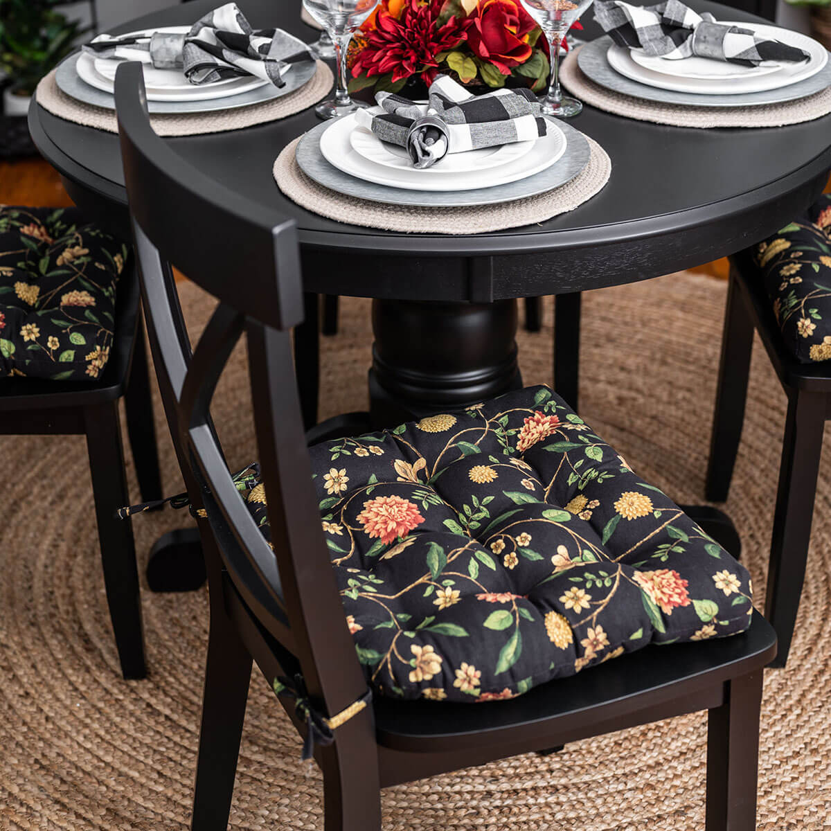 black floral dining chair pad on black dining chairs in formal dining room