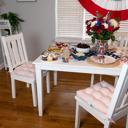 red ticking stripe dining chair cushions on white dining chairs at 4th of july celebration