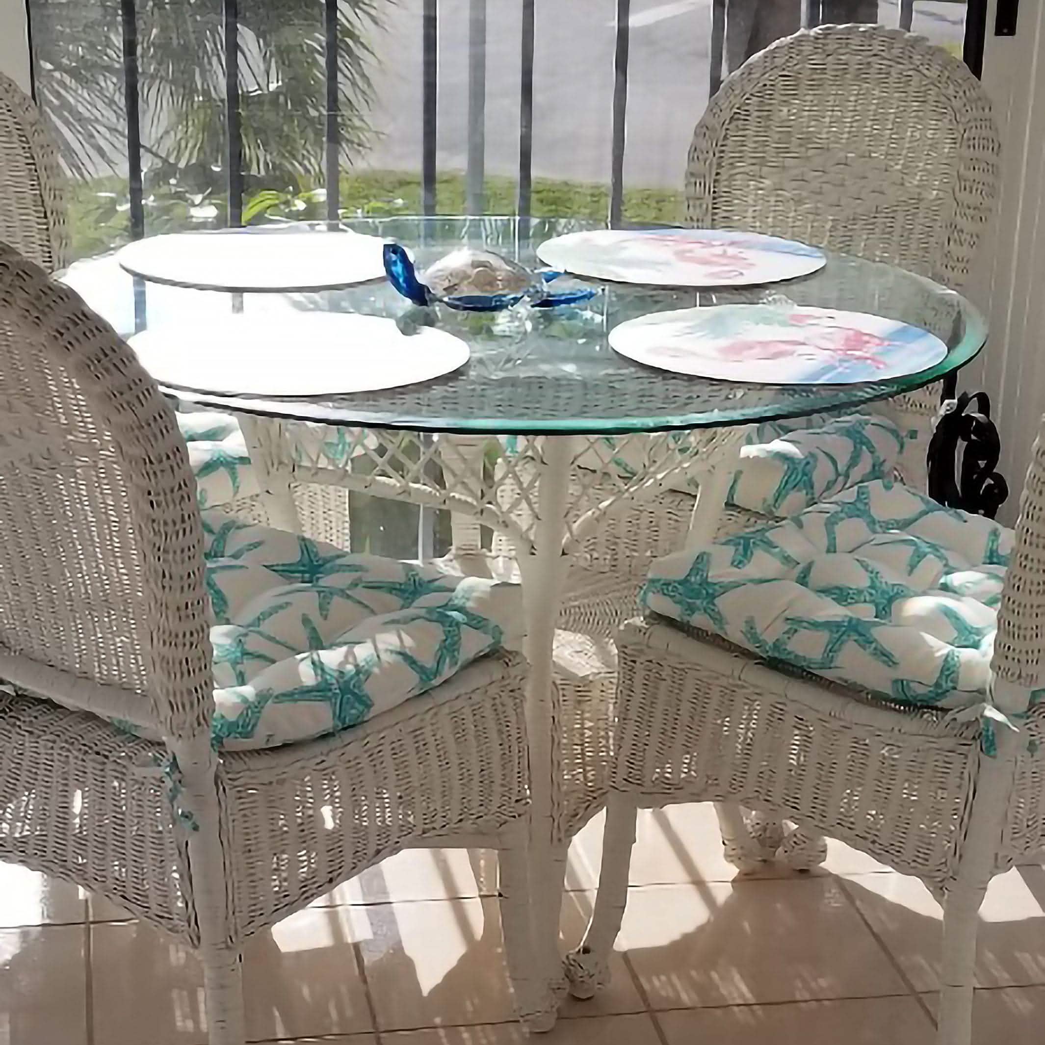 Close-up view of aqua starfish dining chair cushions showing detailed pattern and texture