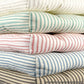 stack of ticking striped dining chair cushions available in 5 colors