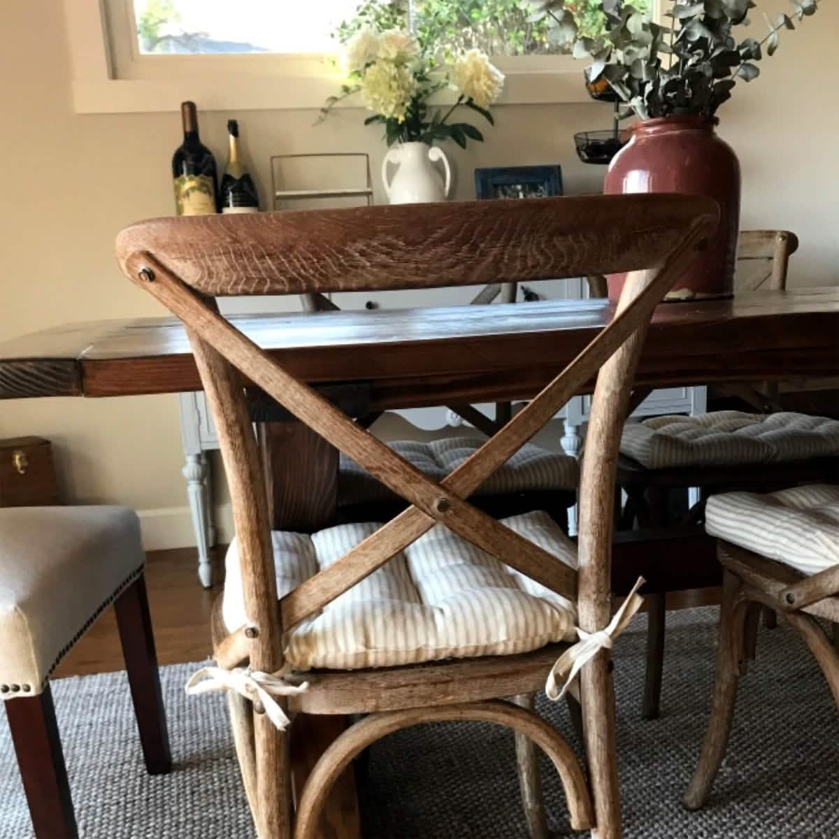 natural cotton ticking striped chair pads on crossback dining chairs at rustic dining table